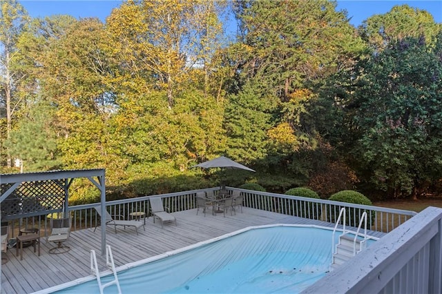 view of pool with outdoor dining area and a deck