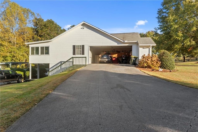 view of home's exterior featuring aphalt driveway and a lawn