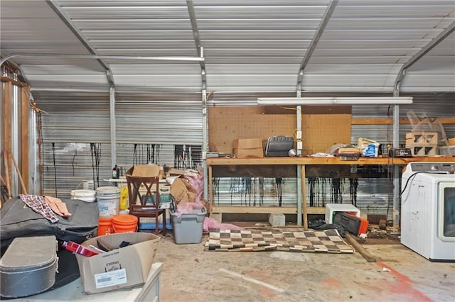 garage with metal wall and washer / clothes dryer