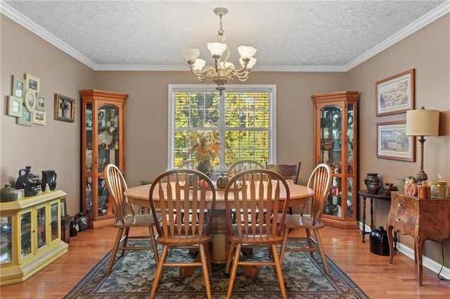 dining area with a chandelier, a textured ceiling, and light wood-type flooring