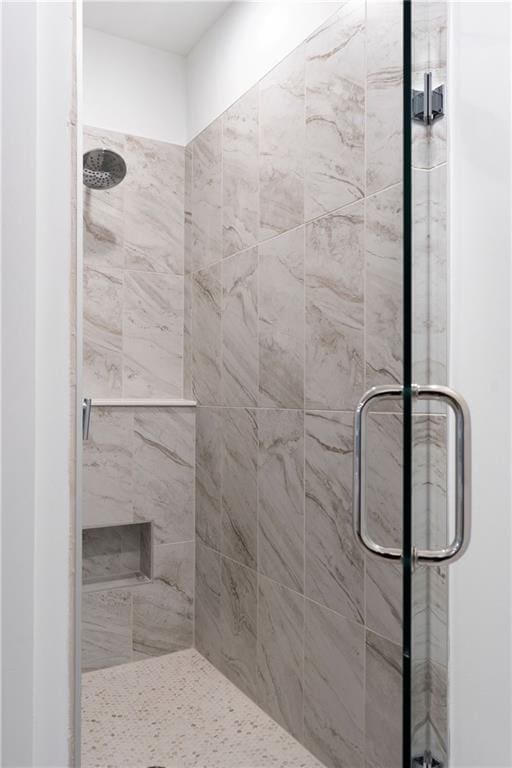 bathroom with a shower with shower door