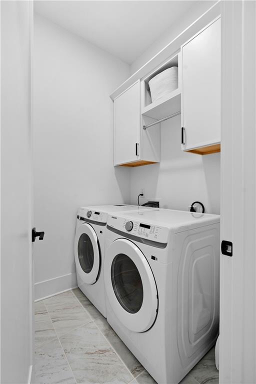 laundry area with cabinets and separate washer and dryer