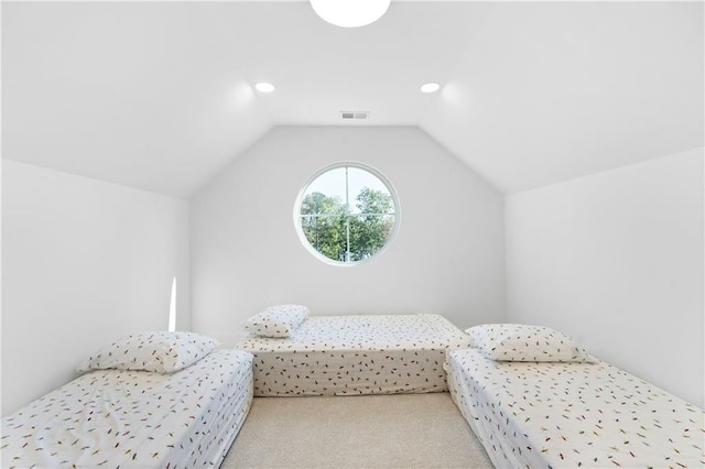 bedroom featuring lofted ceiling and carpet flooring