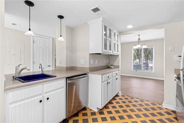 kitchen with sink, white cabinetry, stainless steel appliances, and an inviting chandelier