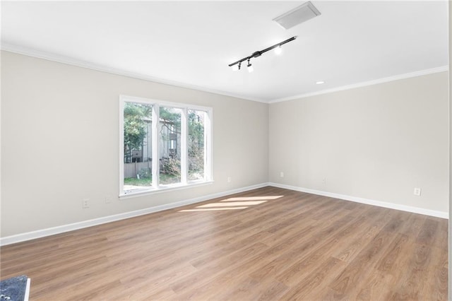 unfurnished room with light hardwood / wood-style flooring, rail lighting, and ornamental molding