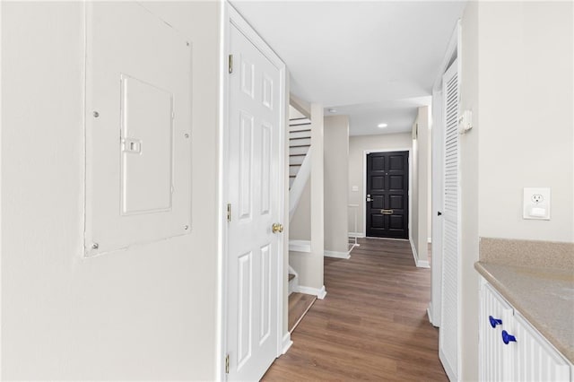 corridor featuring hardwood / wood-style flooring and electric panel