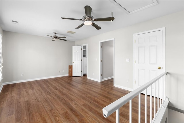 unfurnished room featuring ceiling fan and dark hardwood / wood-style flooring