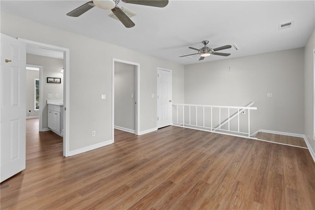 unfurnished room featuring hardwood / wood-style floors and ceiling fan