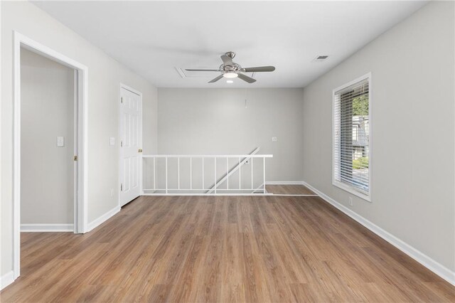 unfurnished room featuring hardwood / wood-style floors and ceiling fan