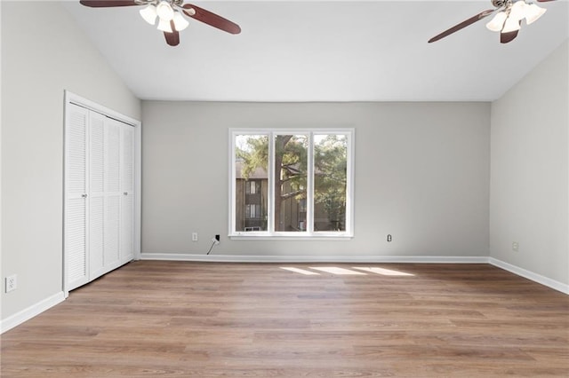 unfurnished bedroom featuring ceiling fan, vaulted ceiling, and light wood-type flooring