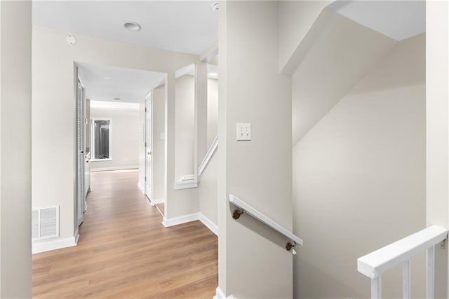 hallway with light hardwood / wood-style floors