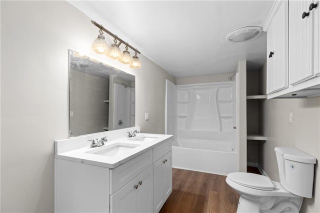 bathroom with hardwood / wood-style floors, vanity, and toilet