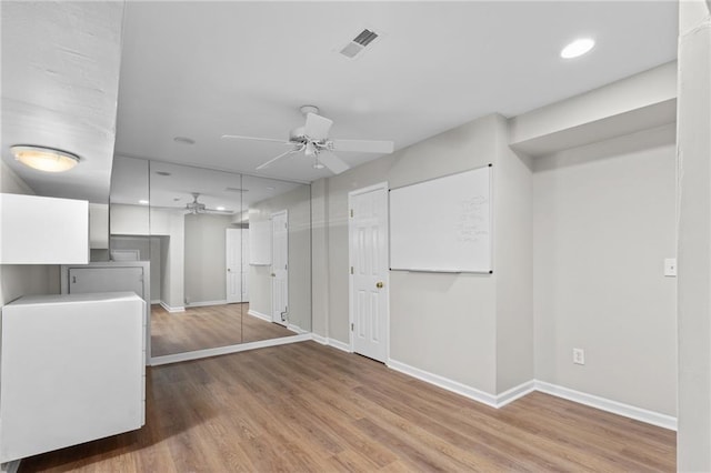 interior space featuring hardwood / wood-style flooring and ceiling fan