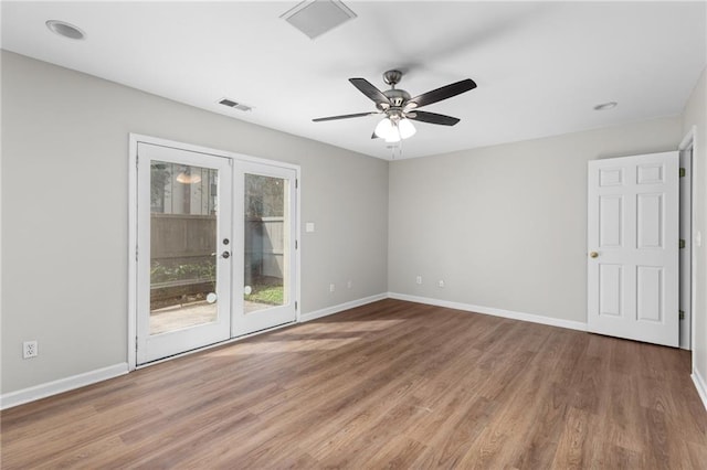 empty room with french doors, hardwood / wood-style flooring, and ceiling fan