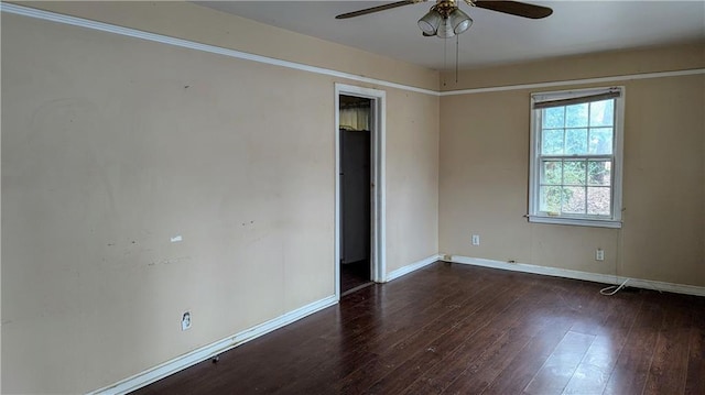 empty room featuring ceiling fan and dark hardwood / wood-style floors