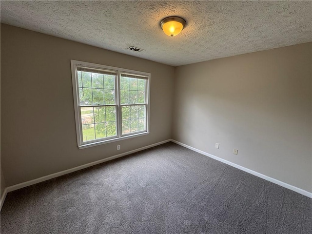unfurnished room featuring baseboards, visible vents, and plenty of natural light