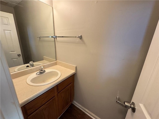 bathroom with baseboards and vanity