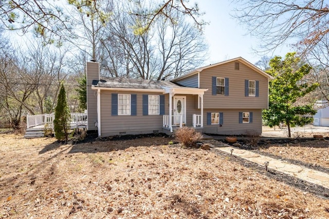 split level home featuring crawl space and a chimney