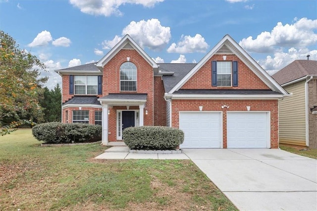 view of property with a garage and a front yard