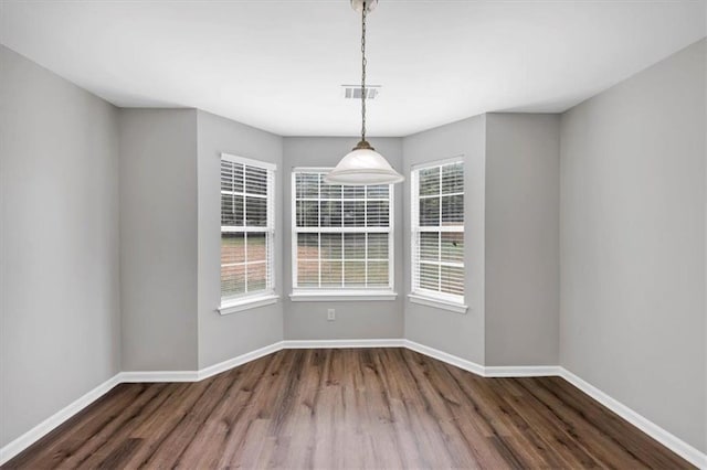 unfurnished dining area with dark hardwood / wood-style flooring