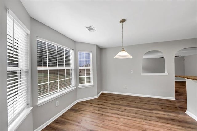 unfurnished dining area with hardwood / wood-style floors