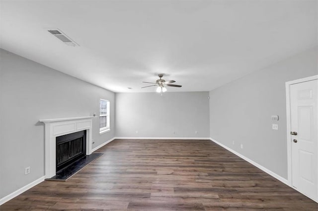 unfurnished living room with ceiling fan and dark hardwood / wood-style flooring