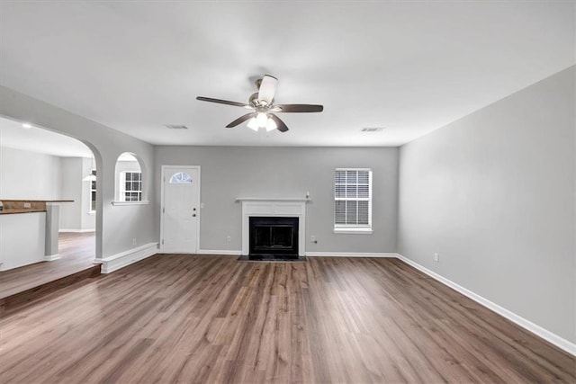 unfurnished living room with hardwood / wood-style floors and ceiling fan