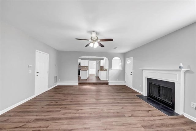 unfurnished living room with hardwood / wood-style floors and ceiling fan