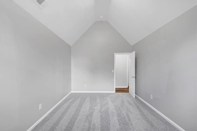 interior space featuring carpet floors and vaulted ceiling