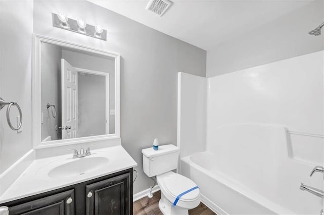 full bathroom featuring shower / bath combination, vanity, toilet, and wood-type flooring