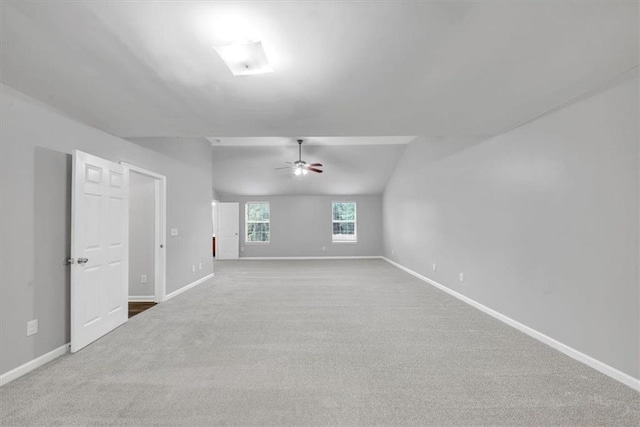 carpeted empty room featuring ceiling fan and lofted ceiling