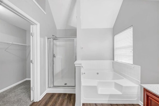 bathroom featuring vanity, lofted ceiling, and shower with separate bathtub