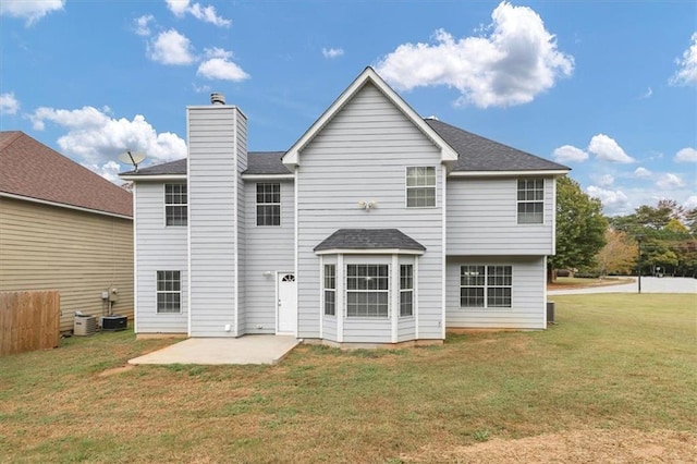 back of house with a patio area and a lawn