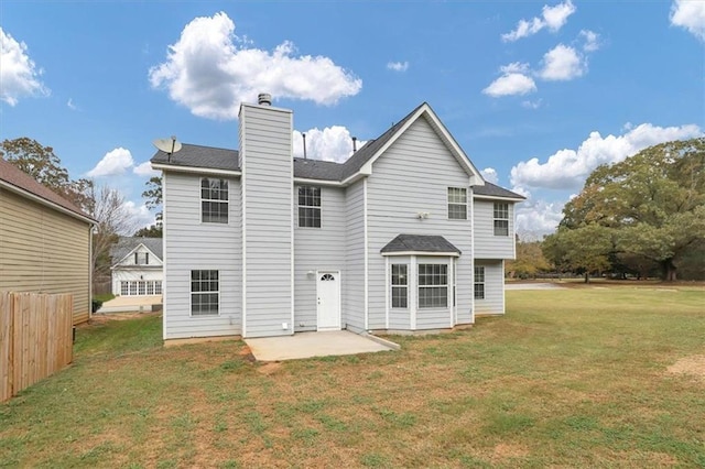 back of property with a patio area and a yard