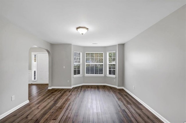 empty room with dark wood-type flooring