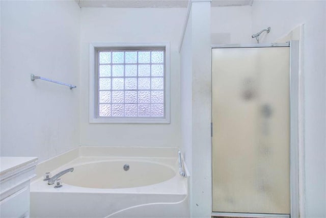 bathroom featuring vanity and shower with separate bathtub