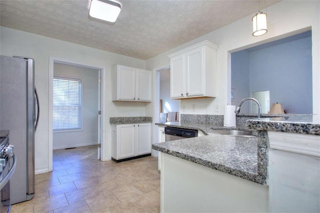 kitchen featuring white cabinetry, sink, hanging light fixtures, and appliances with stainless steel finishes