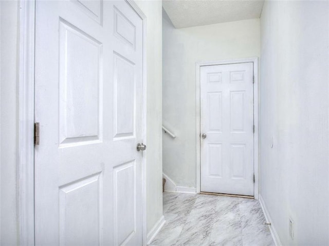 corridor with a textured ceiling