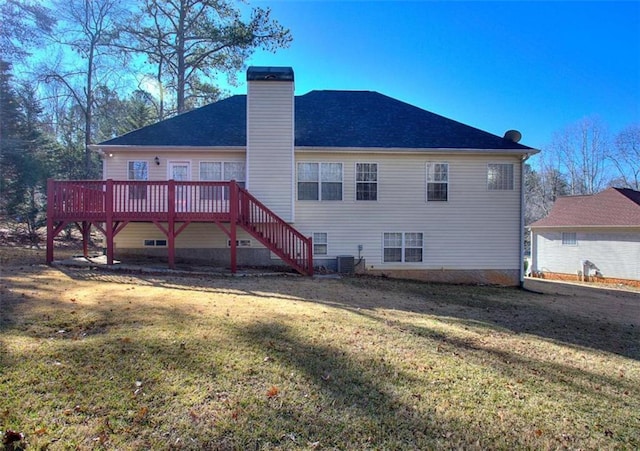 rear view of house with a lawn and a wooden deck