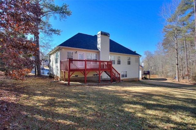 rear view of property featuring a lawn and a deck