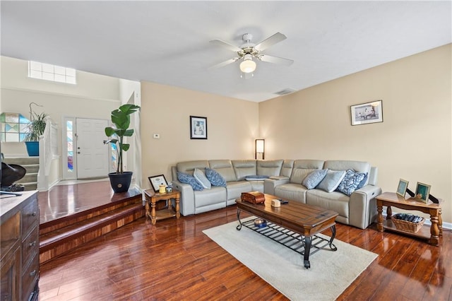 living room with dark hardwood / wood-style flooring and ceiling fan