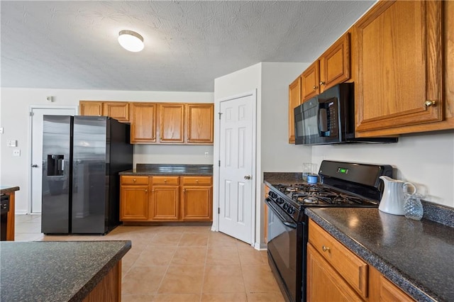 kitchen featuring light tile patterned floors and black appliances