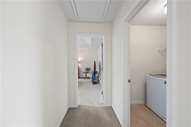 interior space featuring washer / dryer and light colored carpet