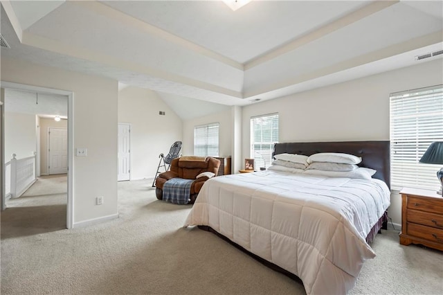 carpeted bedroom featuring high vaulted ceiling and a tray ceiling