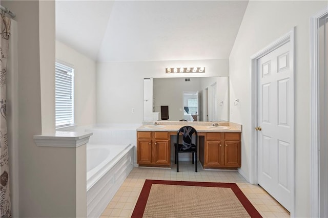 bathroom featuring tile patterned floors, double vanity, lofted ceiling, and tiled bath