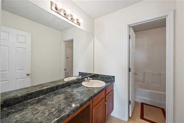 bathroom featuring bathing tub / shower combination, tile patterned floors, and vanity