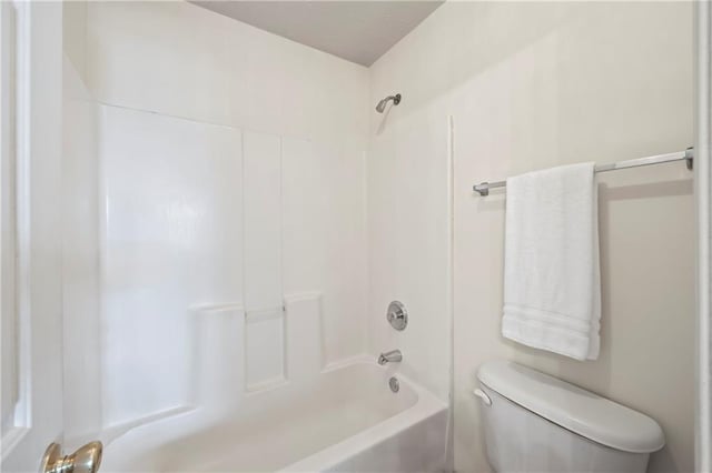 bathroom with shower / bathing tub combination and toilet