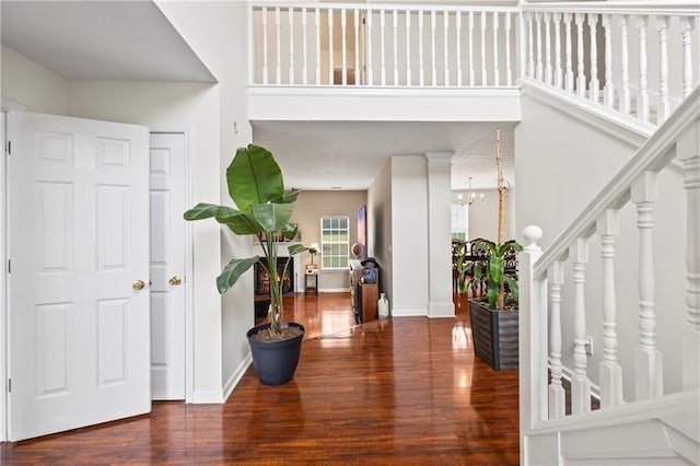 entryway with a notable chandelier and wood-type flooring