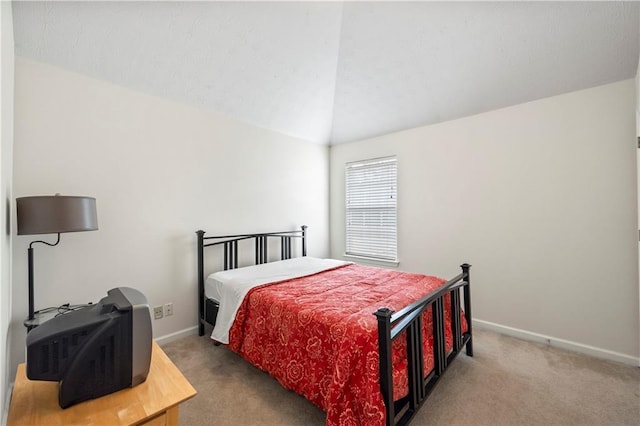 bedroom with vaulted ceiling and carpet flooring