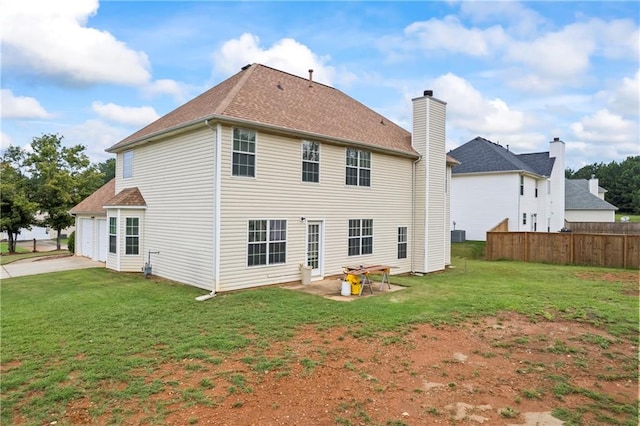 back of property featuring a patio area and a yard